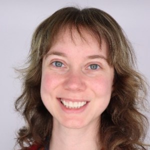Image of smilling woman with brown hair and bangs
